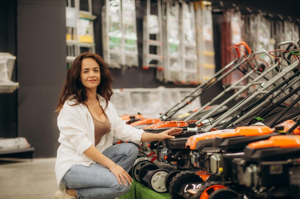 a woman buys a lawnmower in a store