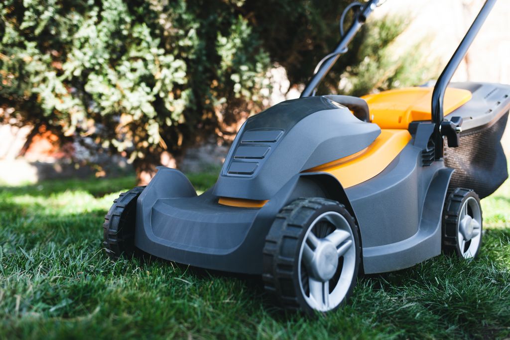 electric lawn mower on a lawn