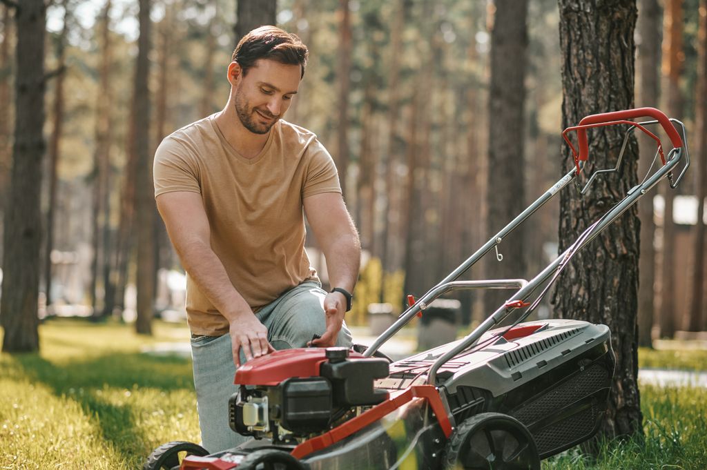 experienced home gardener near lawn mower