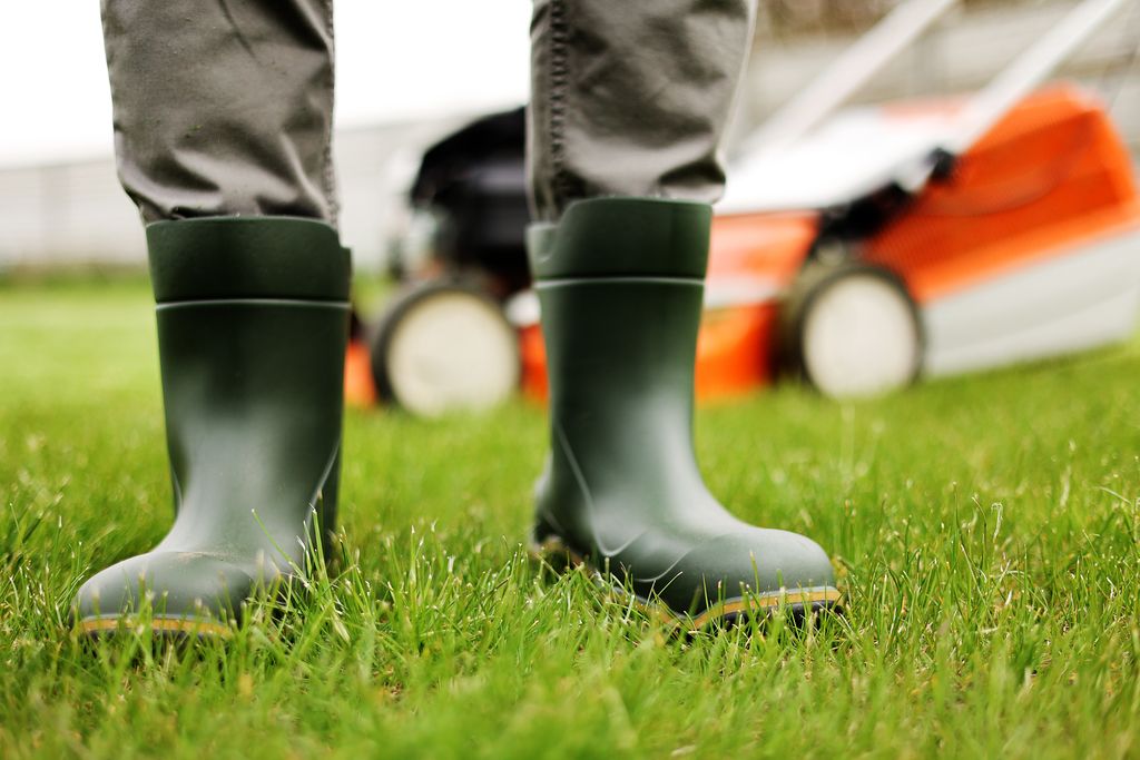 gardener legs in rubber boot