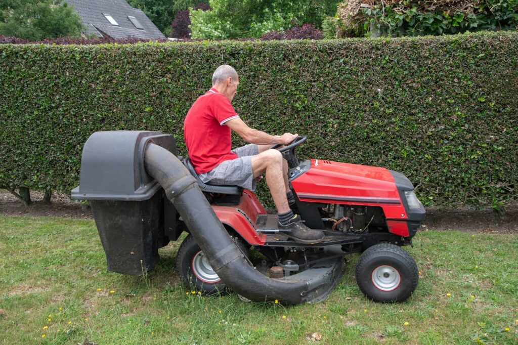 Riding Lawnmower mows the grass.