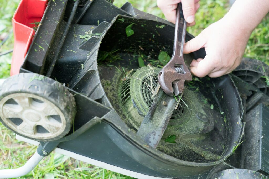 Man repairing a lawn mower