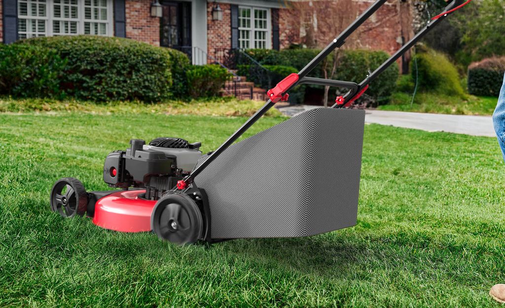 A lawn mower in use on a neatly manicured lawn.