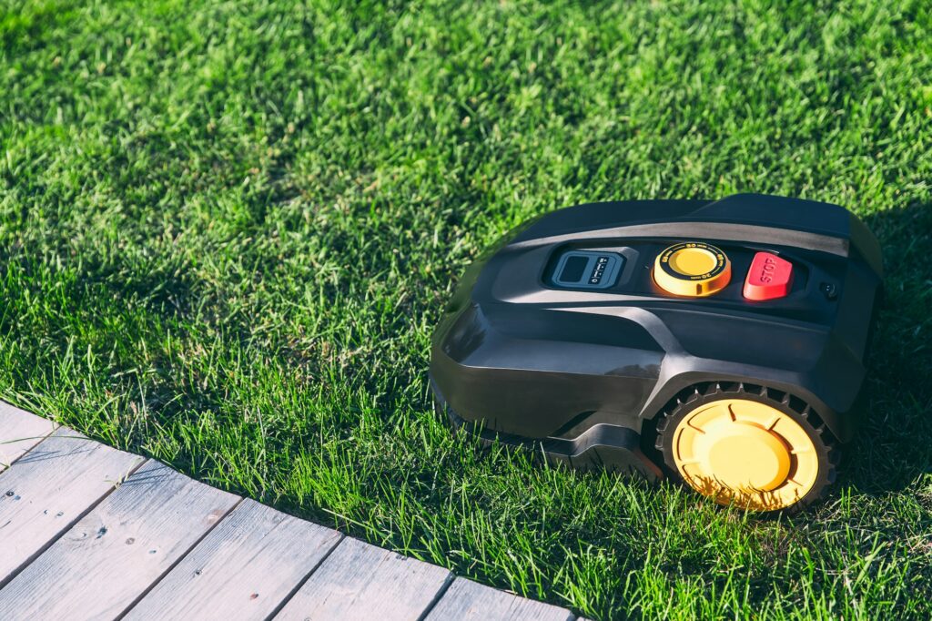 Robotic Lawn Mower cutting grass in the garden.