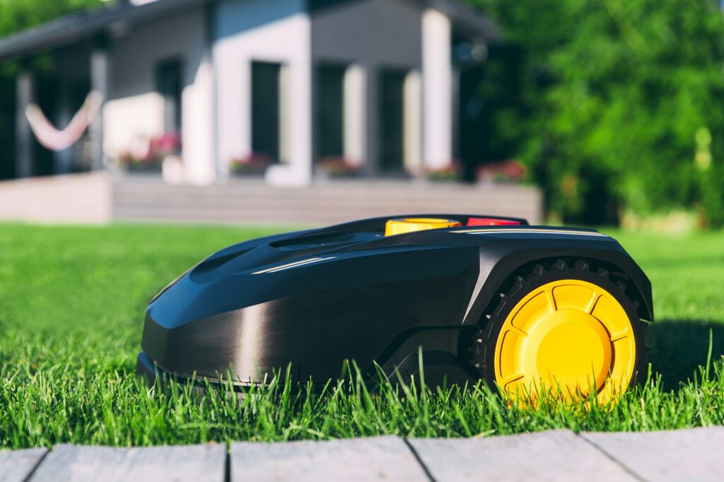 Robotic Lawn Mower cutting grass in the garden.