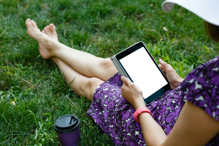 Woman on grass with tablet